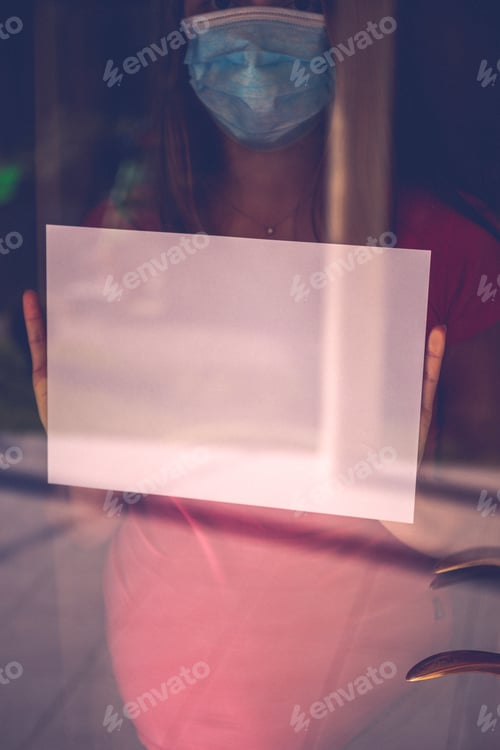 Preview: Coronavirus Covid-19 Crisis Quarantine. Desperate Scared Woman With Face Mask In The Window. Stay