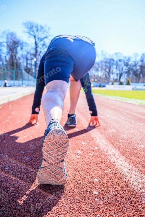Preview: Feet On Starting Block Ready For A Spring Start. Focus On Leg Of A Athlete About To Start A Race In