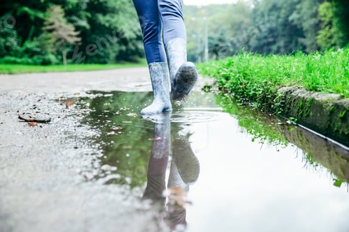 Preview: Woman Legs Walking By Puddle In Rubber Boots