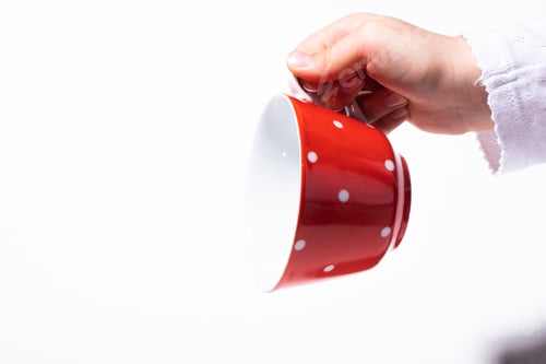 Preview: Child Hand Holding Tea Cup.