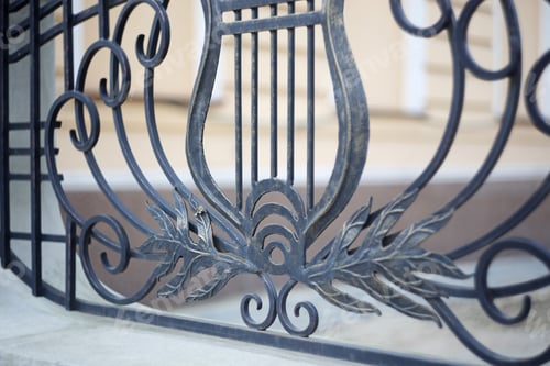 Preview: Ornate Metalwork with Harp Motif on Building Exterior