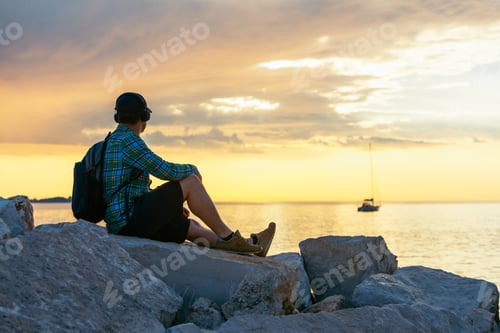 Preview: Man With Backpack Looking On Sunset Over The Sea. Copy Space