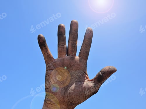 Preview: Open Right Man'S Hand Smeared With Black Soot Against The Blue Clear Sky