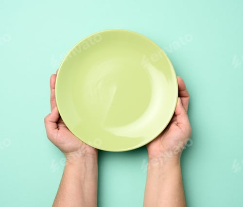 Preview: Two Hands Holding A Round Empty Green Plate, Top View