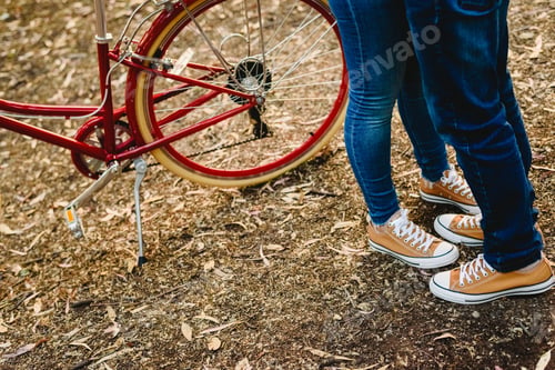 Preview: Couple Of Lovers With Green Sneakers And Jeans Standing Next To A Vintage Bicycle