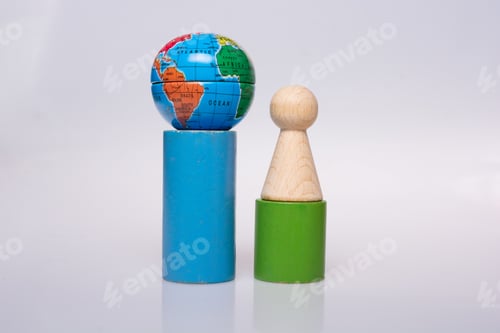 Preview: Wooden Figurines Of People Aand A Mini Globe On White Background