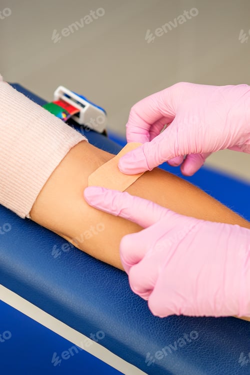 Preview: Close Up Of Nurse Hand Applying Adhesive Plaster On Arm Of Patient After Blood Collection In The