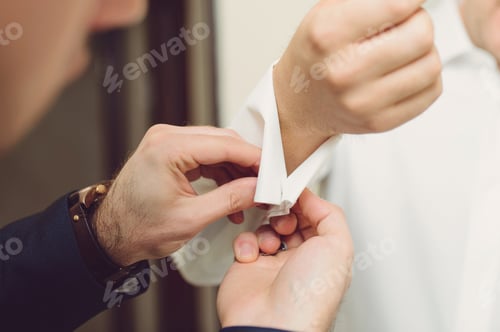 Preview: Man Fastening Cufflinks on White Shirt Sleeve