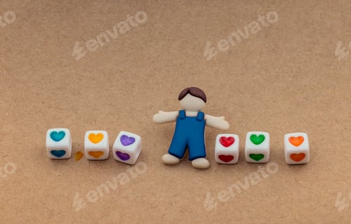 Preview: Little Boys Figurine And Heart Cubes On Notebook