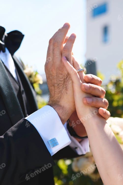 Preview: Bride And Groom Touching Hands In Sunshine At Park