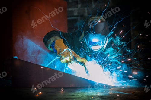 Preview: Worker Welding Metal With Sparks At Factory