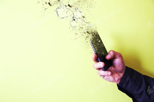 Preview: Man Is Holding Smartphone In Hands Isolated On Yellow Background. Smartphone Falling Into Pieces