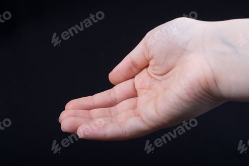 Preview: Five Fingers Of A Child Hand Partly Seen In Black Background