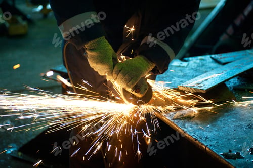 Preview: Worker Welding Metal With Sparks At Factory