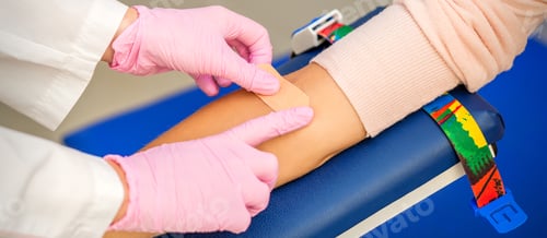 Preview: Close Up Of Nurse Hand Applying Adhesive Plaster On Arm Of Patient After Blood Collection In The