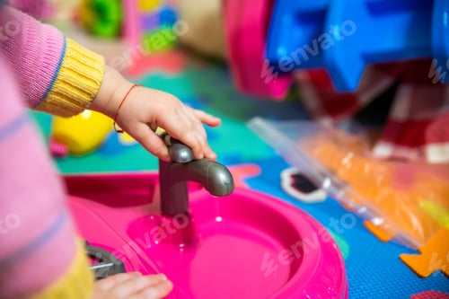 Preview: Baby Girl Play With Plastic Kitchen Toys Close Up