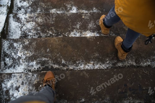 Preview: Man And Woman Legs Waking By Icy Slippery Stairs