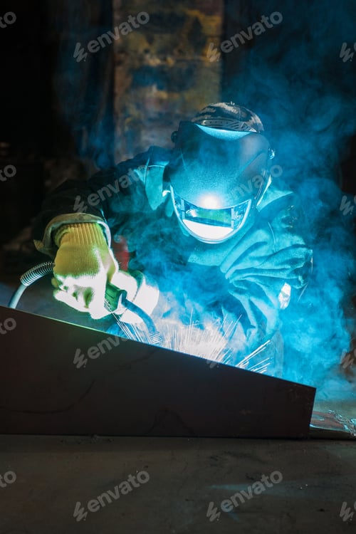 Preview: Worker Welding Metal With Sparks At Factory