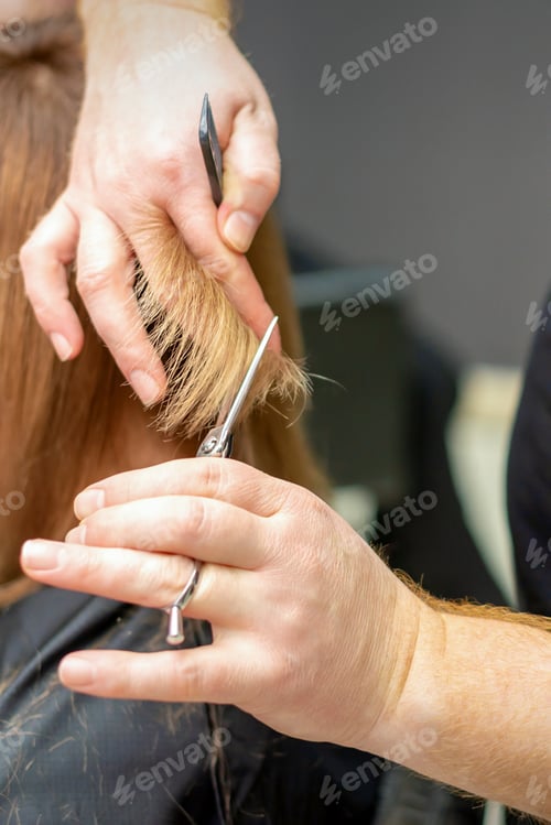 Preview: Close-Up Back View Of Hairdresser Cuts Red Or Brown Hair To Young Woman In Beauty Salon. Haircut In