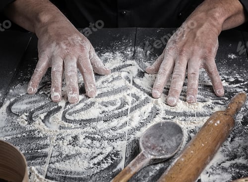 Preview: Men'S Hands Stir The White Wheat Flour On A Black Wooden Table