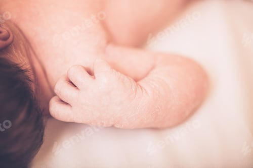 Preview: Close-Up Newborn Baby On Bed With Lots Of Dark Hair.