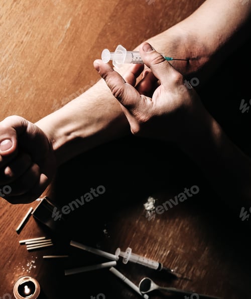 Preview: Man Shooting Heroin With Needle Syringe. Drugs Addict. Candle Burning With Matches And Cigarettes