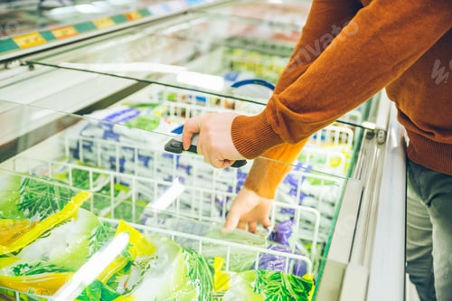 Preview: Man Get Frozen Food From Fridge In Store. Shopping Concept