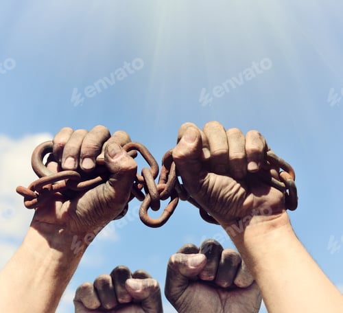 Preview: Two Dirty Male Hands Wrapped In A Rusty Iron Chain Raised Up Against A Blue Sky And Sun
