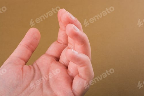 Preview: Hand Making A Gesture On A Wooden Background
