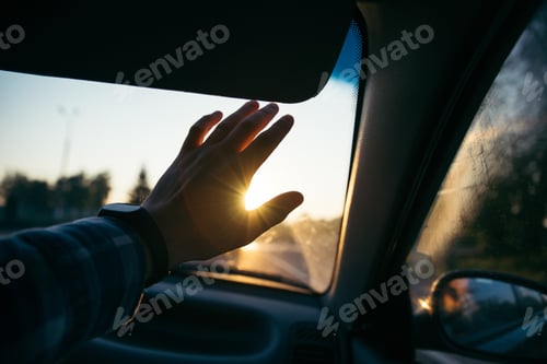 Preview: Man Hold Hand In Front Of The Sun On Sunset In The Car