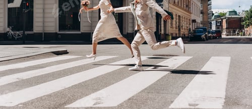 Preview: Bridal Couple Running Across The Street In Copenhagen. Wedding Agency Concept.