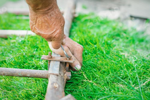 Preview: Hand Of An Elderly Man Twisting The Nut With A Wrench Outdoors. Repair By Wrench.
