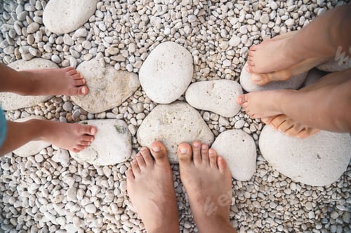 Preview: Family Feet Standing On Stone Beach