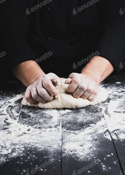 Preview: Male Hands Substitute White Wheat Flour Dough On A Black Wooden Background