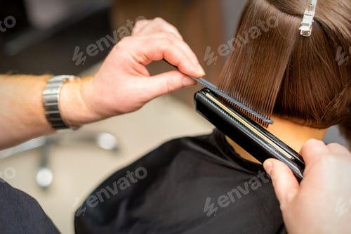 Preview: Close Up Of The Hairdresser Straightening The Short Hair Of A Female Client With A Hair