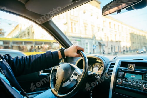 Preview: Man Driving Car By City Streets. View From Inside