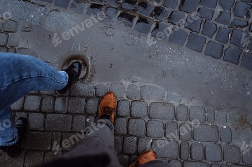 Preview: People Legs Next To Puddle. Rainy Weather.
