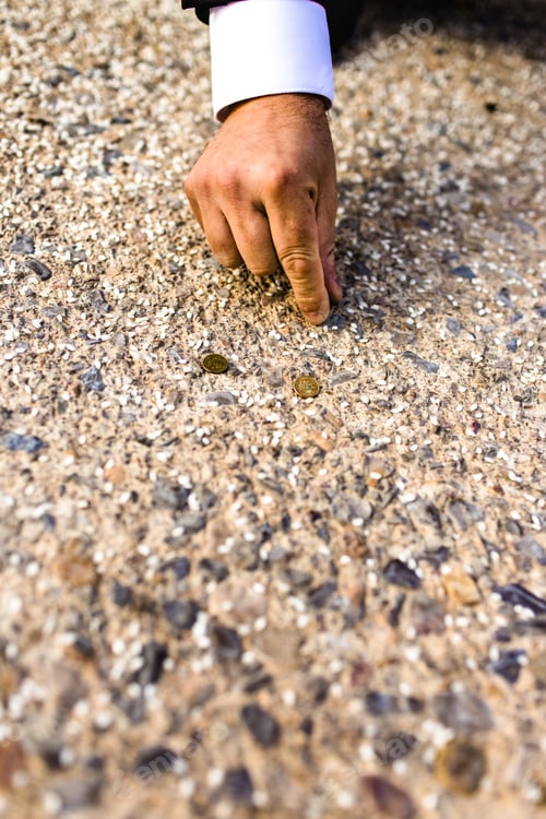 Preview: Businessman Hand Picking Up Some Coins That Have Fallen To The Ground, Concept Of Opportunities.
