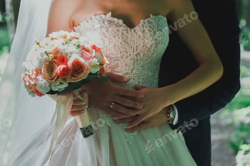 Preview: Beautiful Bride In Wedding Satin Lace Dress Without Shoulders Is Hugging With Her Groom. Colorful