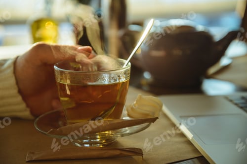 Preview: Close Up Of A Man Drinking Coffee At A Cafe. Laptop On Background