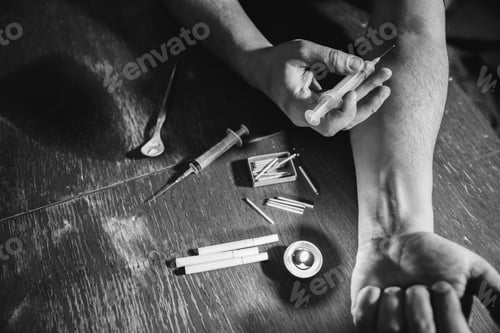 Preview: Man Shooting Heroin With Needle Syringe. Drugs Addict. Candle Burning With Matches And Cigarettes