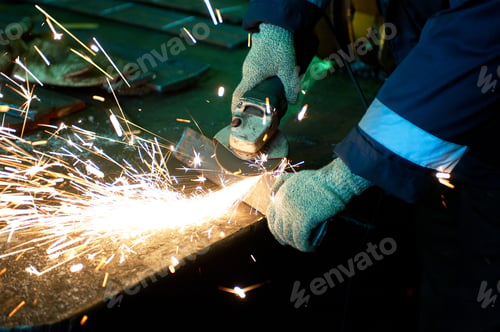 Preview: Worker Welding Metal With Sparks At Factory
