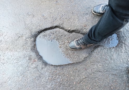 Preview: Man Standing In Shape Of Foot Step. The Asphalt Pavement Outdoors.