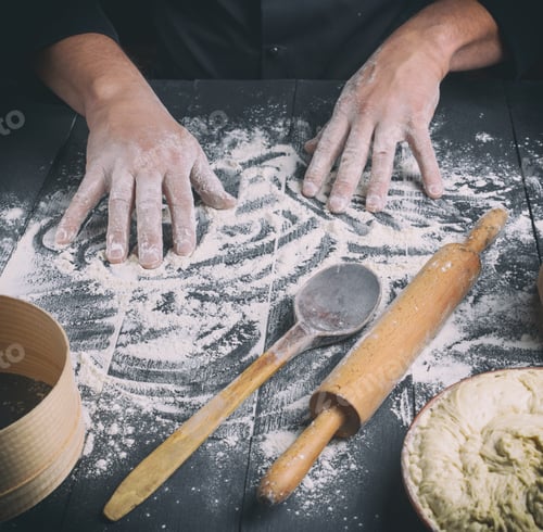 Preview: White Wheat Flour On A Black Wooden Table And Two Male Hands, Close Up