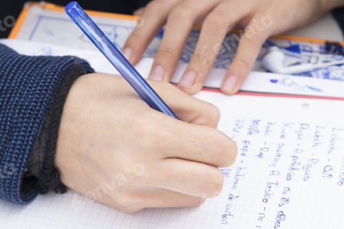 Preview: Child Writing In The Book At School
