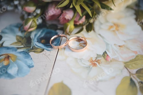Preview: Golden Wedding Rings On Floral Table