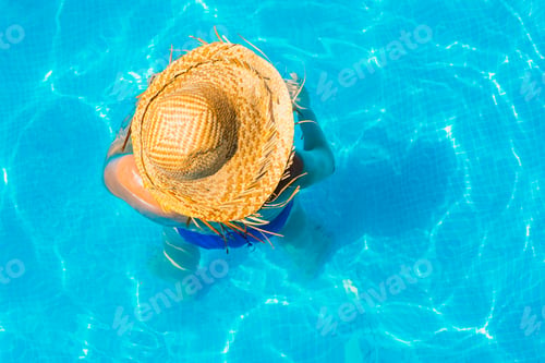 Preview: Woman In A Pool With Hat Relaxed And Rested.