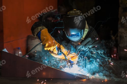 Preview: Worker Welding Metal With Sparks At Factory