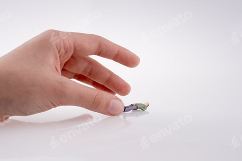 Preview: Hand Holding A Figure On A White Background