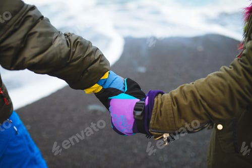 Preview: Couple Holding Hands By Iceland Sea